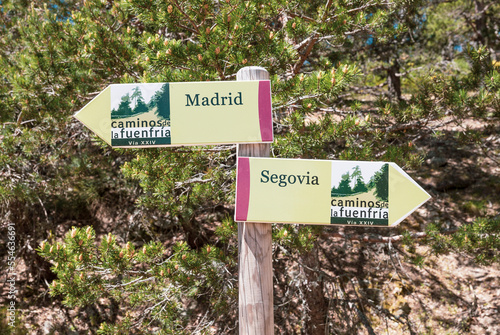 Caminos de la Fuenfria, Via XXIV - wooden signpost pointing the way to Madrid and Segovia, Spain