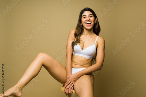 Cheerful woman in underwear promoting body acceptance