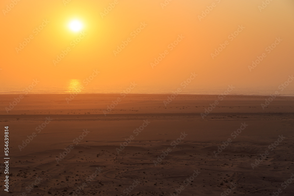 Desert off the coast of the Atlantic Ocean. Beautiful sunset. Walvis Bay. Swakopmund, Namibia.
