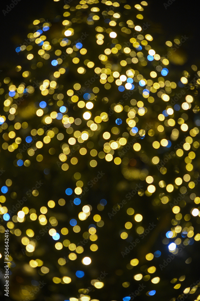 Colorful Red, Yellow and Green Christmas Tree Bokeh background of de focused glittering lights, Christmas background pattern concept.