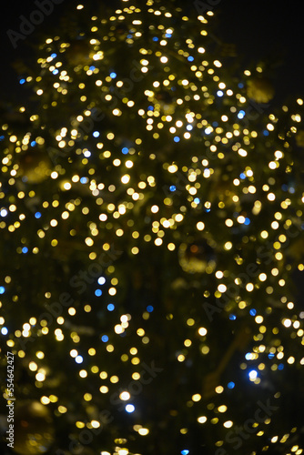Colorful Red, Yellow and Green Christmas Tree Bokeh background of de focused glittering lights, Christmas background pattern concept.