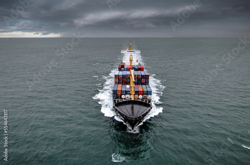 Impressive aerial wide angle view of a container ship crossing the oceans