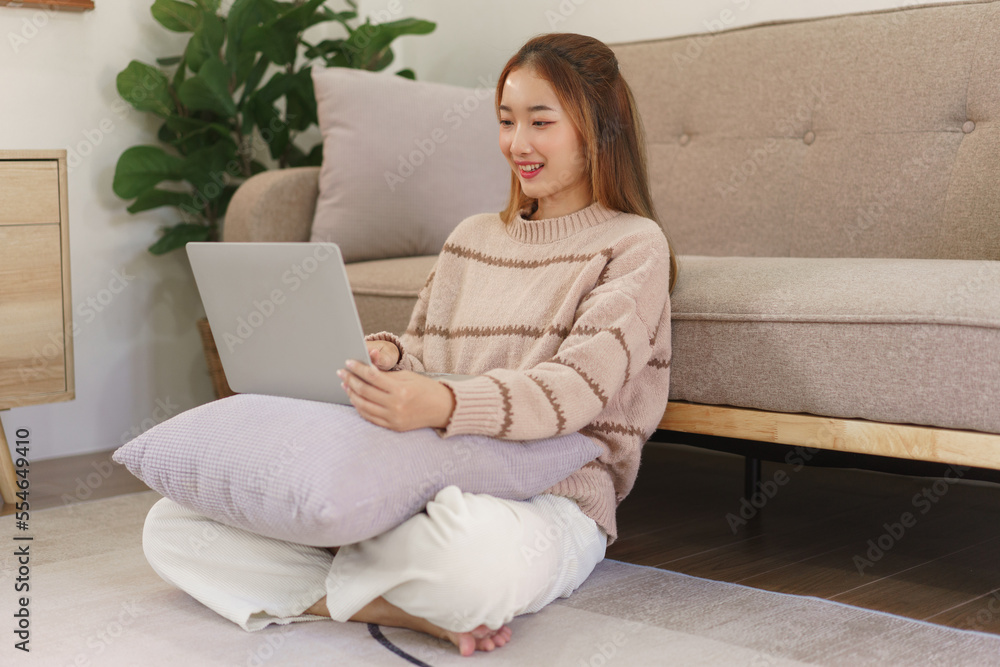Leisure time concept, Women sitting on the floor to working and surfing social media on laptop Leisure time concept, Women sitting on the floor to working and surfing social media on laptop