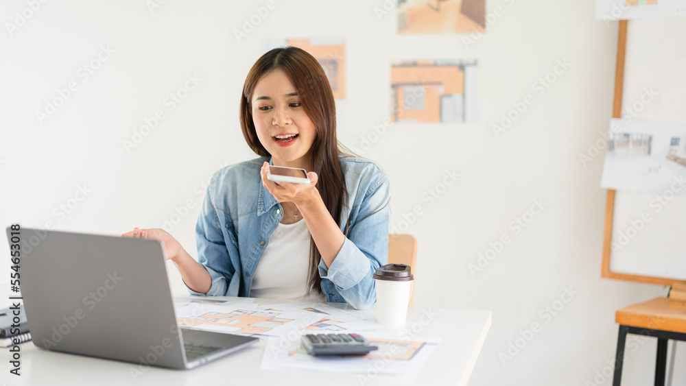 Construction business plan concept, Female architect talk on smartphone during sketching house plan Construction business plan concept, Female architect talk on smartphone during sketching house plan