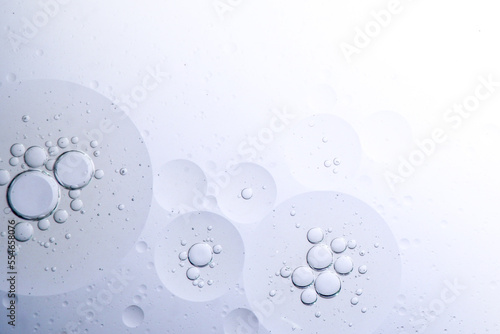 Oil bubbles on the water with White background for cosmetic liquid beauty product. Face serum background . bubbles in water