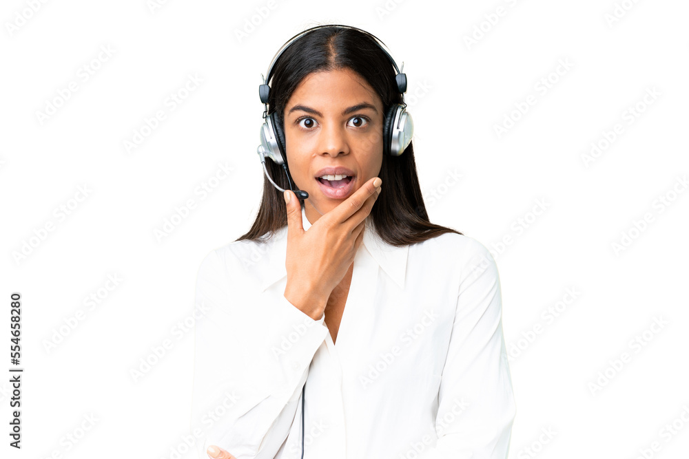 Telemarketer African American woman working with a headset over isolated chroma key background surprised and shocked while looking right Telemarketer African American woman working with a headset over isolated chroma key background surprised and shocked while looking right