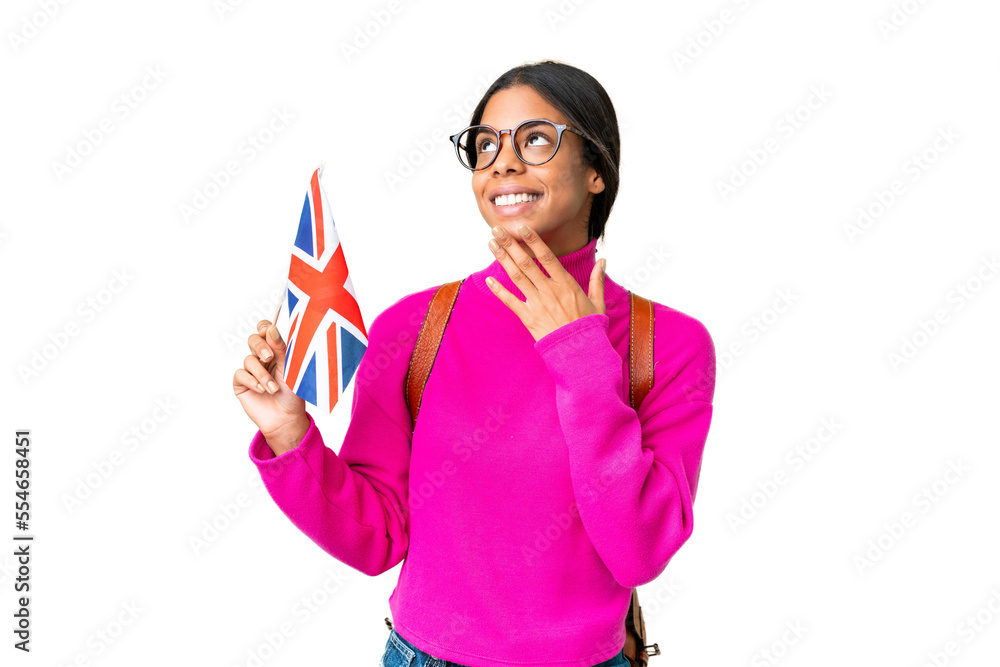 Young African American woman holding an United Kingdom flag over isolated chroma key background looking up while smiling Young African American woman holding an United Kingdom flag over isolated chroma key background looking up while smiling