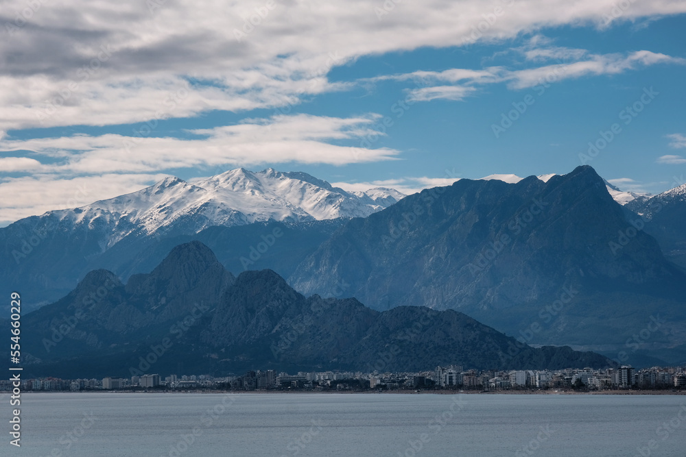 View of Antalya coastline and snowy mountains on cloudy winter day. Turkey.