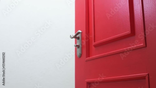 Opening a red door. 4k footage UHD 3840x2160