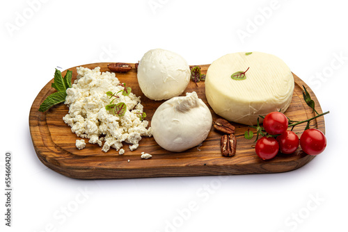 Assorted cheeses on a board with honey and jam