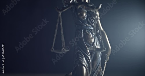 Legal law, patent attorney or successful lawyer concept. Bronze statue of themis or lady of justice on black background.