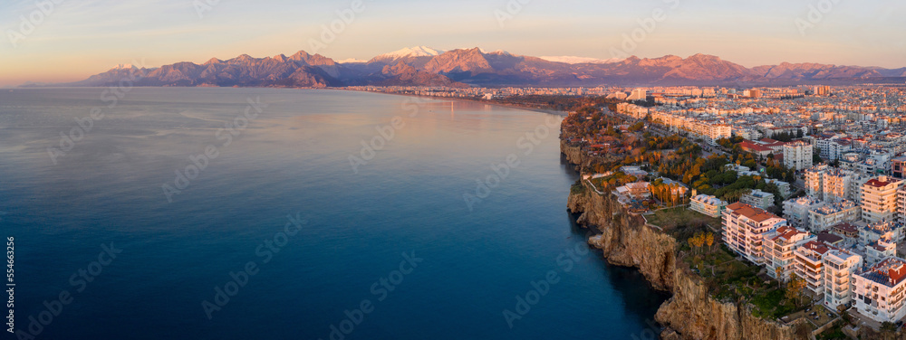 Panoramic aerial view of Antalya and covered with snow mountains at sunrise. Turkey.