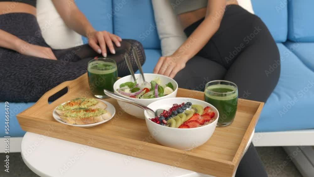 Healthy food concept, a tray with salads and healthy herb drinks, womans hands picking up the drinks from the tray Healthy food concept, a tray with salads and healthy herb drinks, womans hands picking up the drinks from the tray
