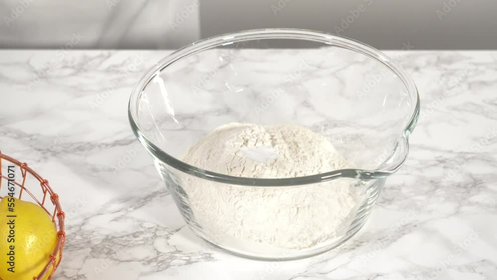Step by step. Mixing ingredients in a glass mixing bowl to prepare lemon bundt cake. Step by step. Mixing ingredients in a glass mixing bowl to prepare lemon bundt cake.