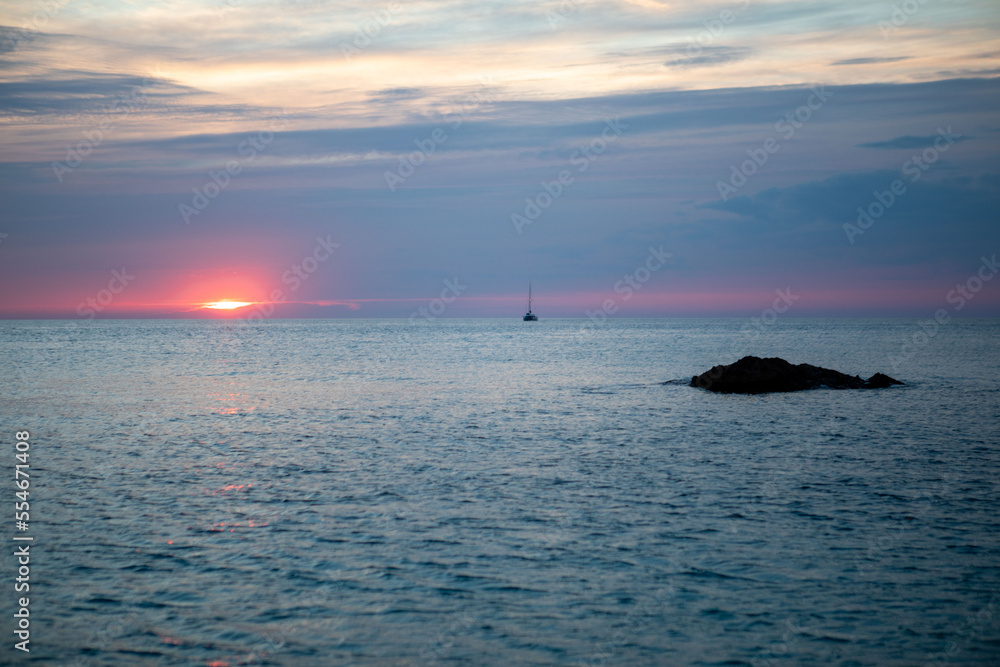 view of the sunset above the sea yacht on the background