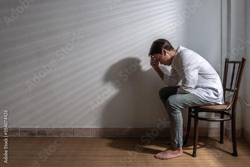 stress asian man nervous headache alone. loneliness frustration male person suffering from isolated tired pressure indoors. lonely attractive mental people depressed pain sad grief with difficulty