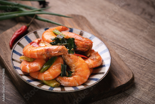 Delicious pan-fried shrimp on dark wooden table background.