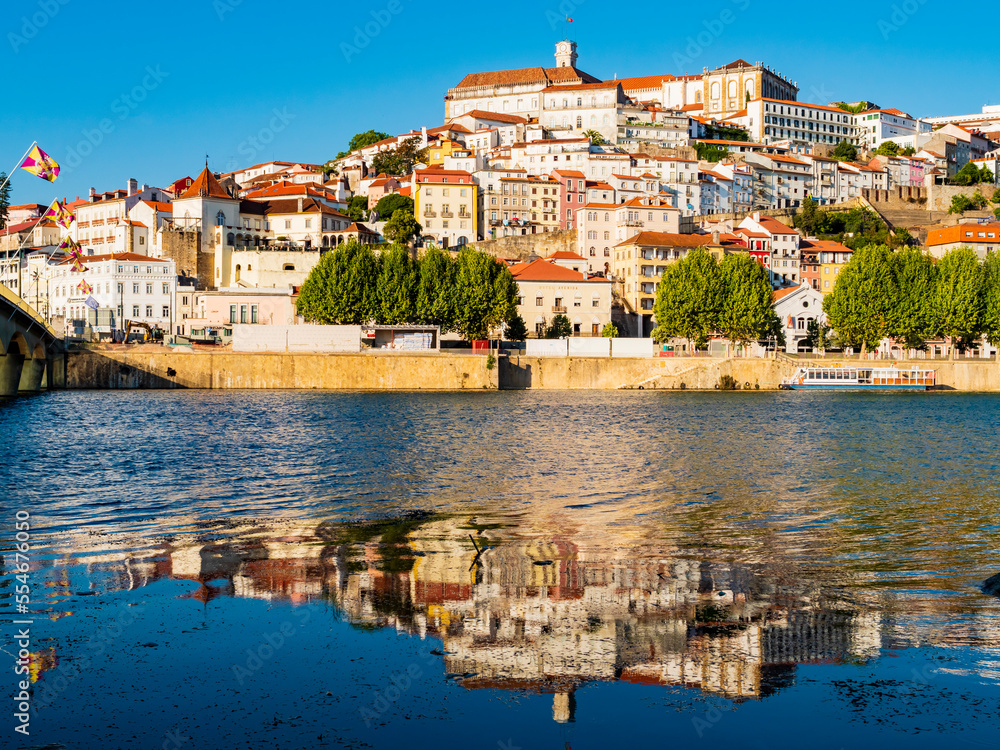 Stunning skyline of Coimbra reflected in Mondego river, Portugal