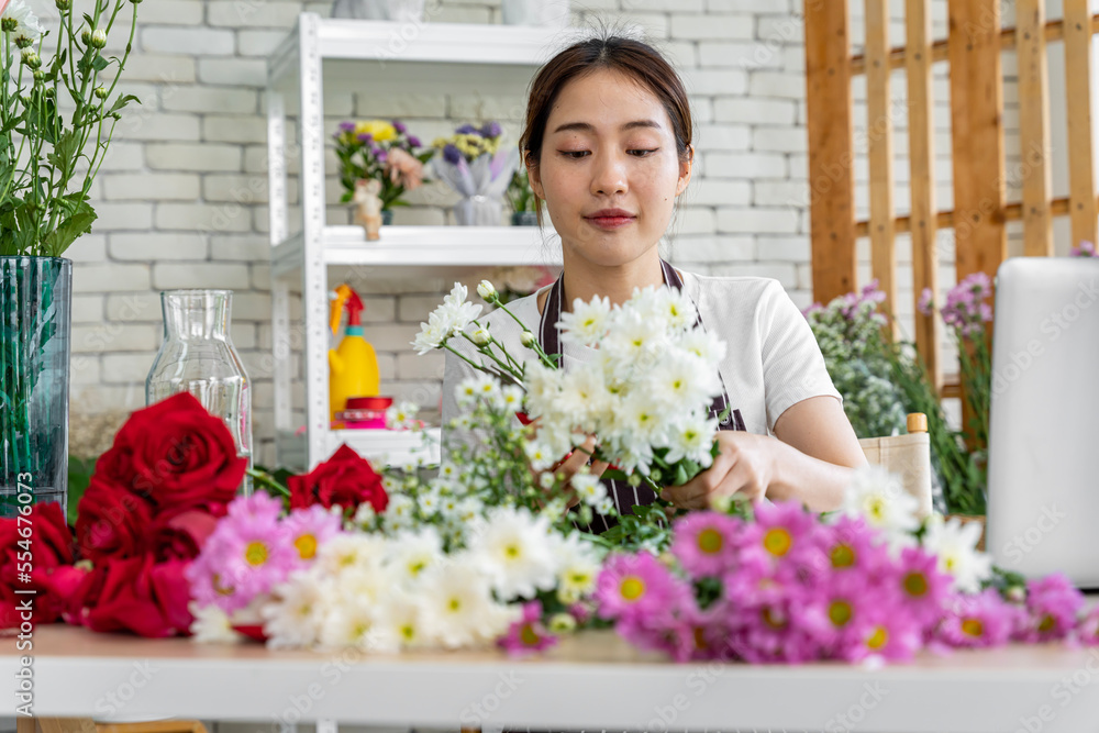 female florists Asians are arranging flowers for customers who come to order them for various ceremonies such as weddings, Valentine's Day or to give to loved ones. female florists Asians are arranging flowers for customers who come to order them for various ceremonies such as weddings, Valentine's Day or to give to loved ones.