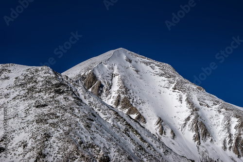 Close view of the Mt. Vihren summit covered by snow in winter sunny day. Pirin national park, Bulgaria.
