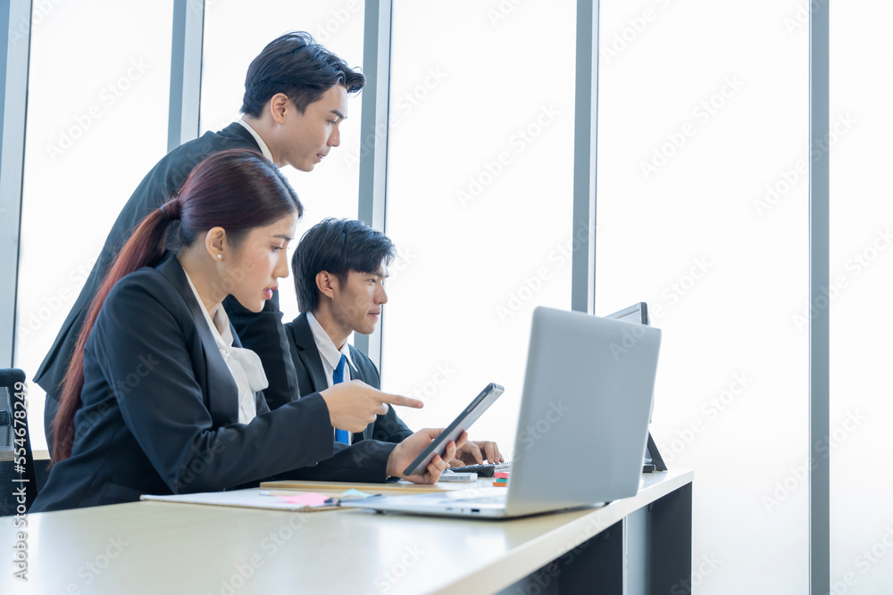 A group of young Asian businessmen Talking and planning work happily and have fun. at the company's office A group of young Asian businessmen Talking and planning work happily and have fun. at the company's office