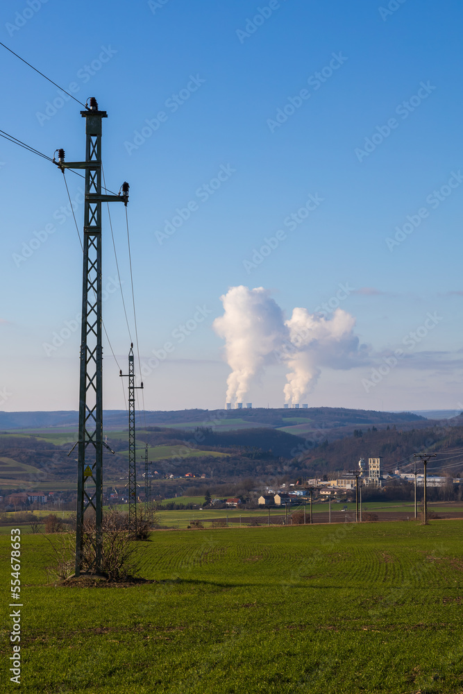 Dukovany nuclear power plant in the Czech Republic, Europe. Smoke cooling towers. There are clouds in the sky. In the foreground is the nature of the Highlands. Dukovany nuclear power plant in the Czech Republic, Europe. Smoke cooling towers. There are clouds in the sky. In the foreground is the nature of the Highlands.