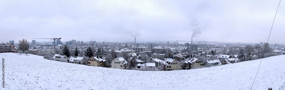 Fototapeta premium Wide angle aerial view over City of Zürich with skyline and snow covered winter landscape on a cloudy late autumn day. Photo taken December 17th, 2022, Zurich, Switzerland.