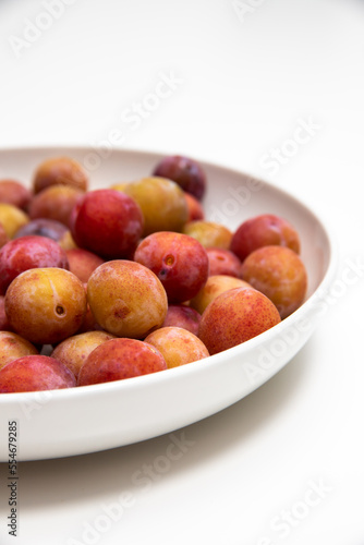 plate full of small raw plums