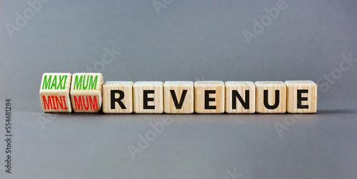 Maximum or minimum revenue symbol. Concept words Maximum revenue and Minimum revenue on wooden cubes. Beautiful grey table grey background. Business maximum or minimum revenue concept. Copy space.