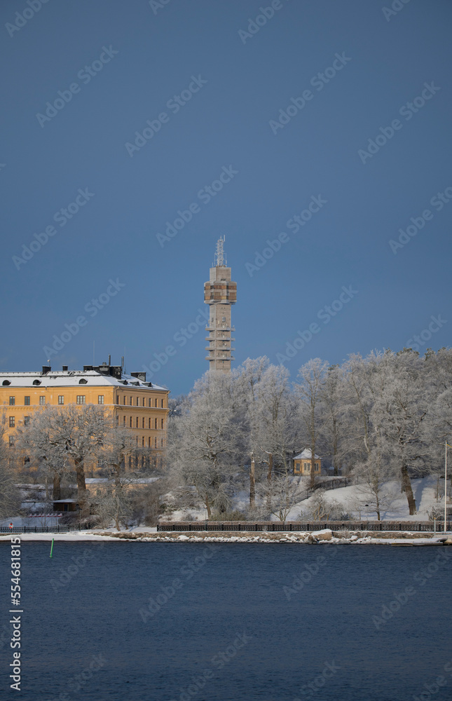 Water front, frosty trees, old school, gazebo and tele tower a snowy blech winter day in Stockholm