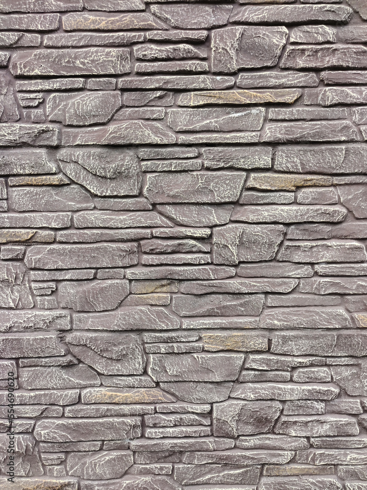 A stone wall of bricks of various shapes on the whole background