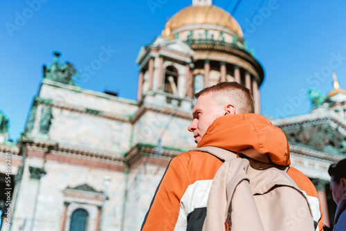 Rear view of a young man walking to St. Isaac's Cathedral in St. Petersburg