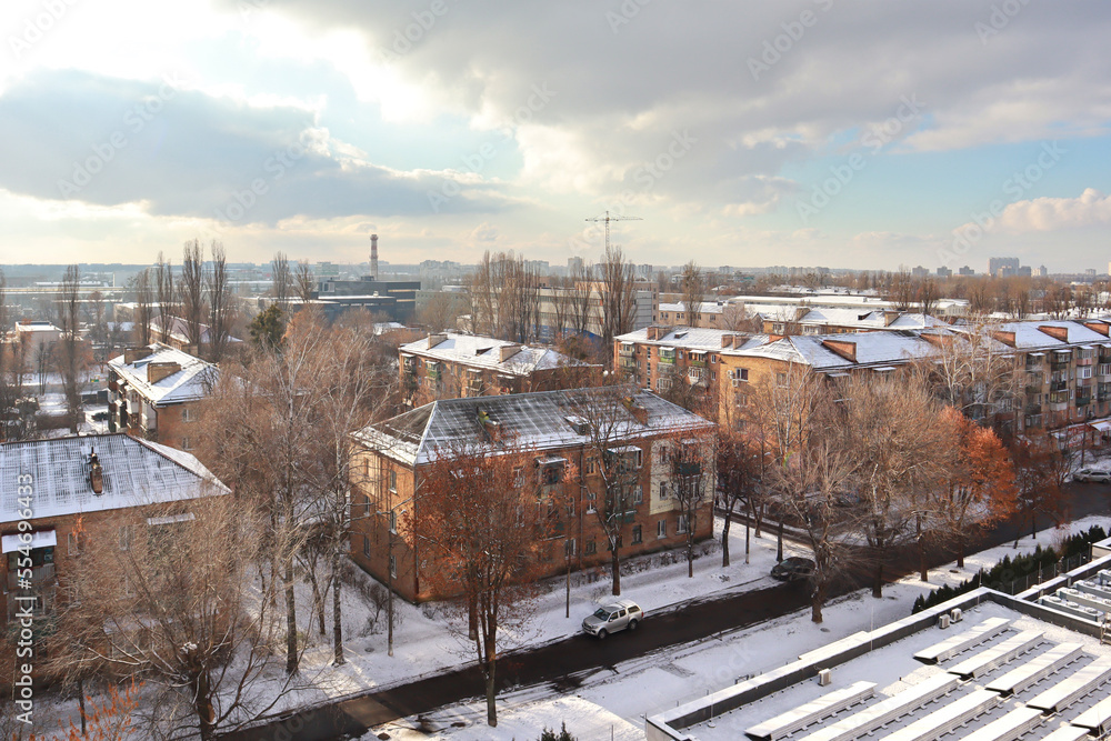 Winter citycape with snow covered trees in sunny day