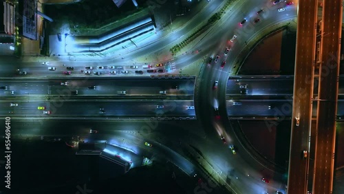 Expressway top view, Road traffic an important infrastructure, aerial view cityscape of advanced innovation, car traffic transportation above intersection road in city night, financial technology	
