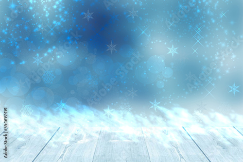 Empty wood floor. Empty rustic wooden table top with snow over abstract light blue winter backdrop with stars. New Year or Christmas template for your product display montage.