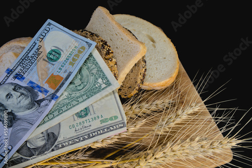 American dollars and slices of bread and ears of wheat