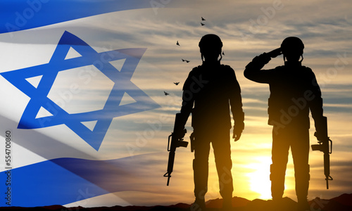 Silhouette of soldiers with Israel flag against the sunrise. Concept - armed forces of Israel. EPS10 vector