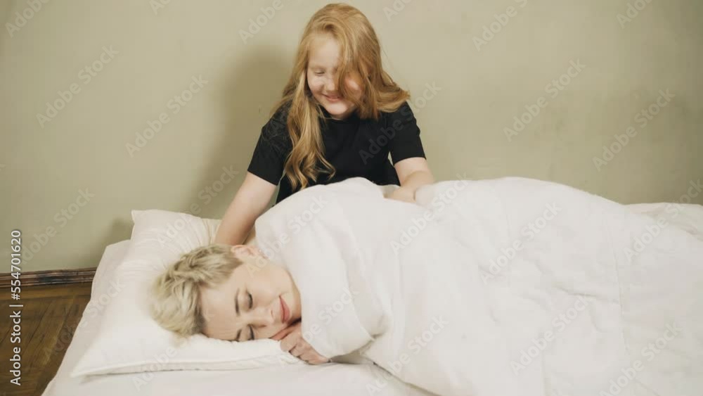 The daughter wakes up her mother, shakes her, she wakes up and hugs her daughter. The daughter wakes up her mother, shakes her, she wakes up and hugs her daughter.