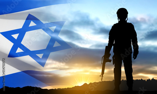Silhouette of soldiers with Israel flag against the sunrise. Concept - armed forces of Israel. EPS10 vector