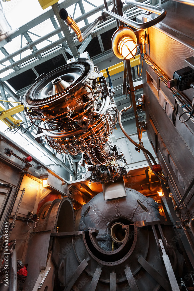 Perform a lift to install a new turbine engine for a power plant Stock