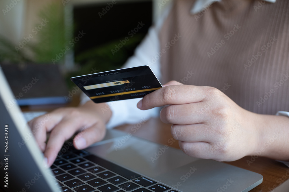 Women purchasing online using credit card payments via laptop, Shopping online and banking online concept.