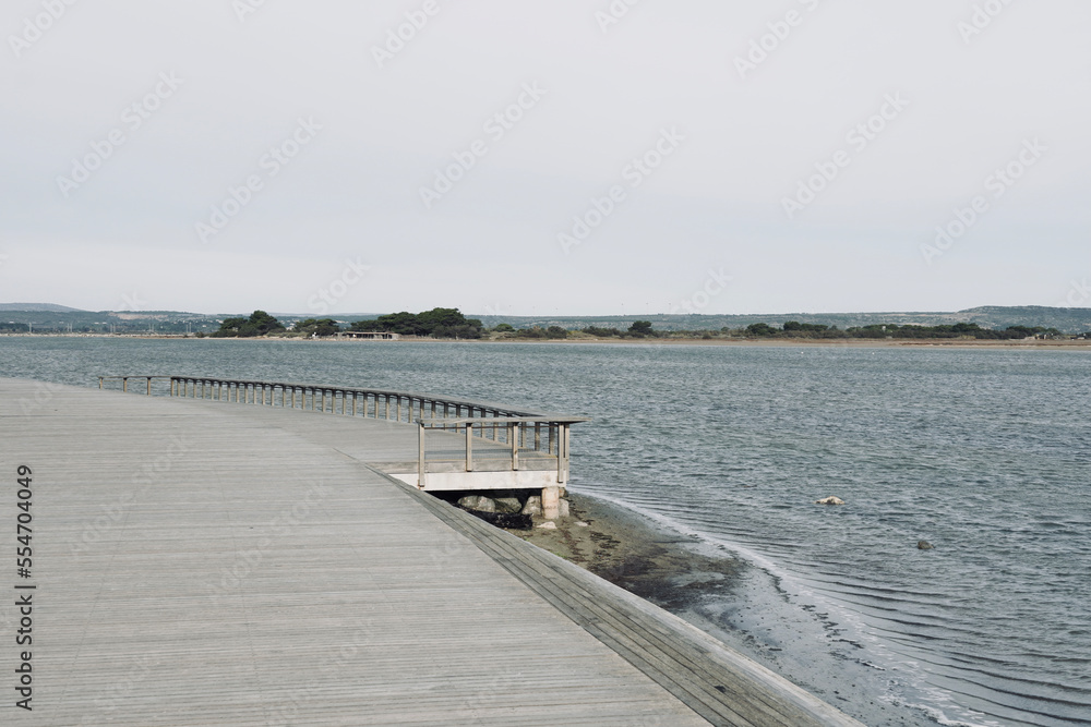Wooden boardwalk on the beach of Leucate in the south of France in Languedoc Roussillon in France. Mediterranean sea with space for text. Landscape in Luecate, Aude. 