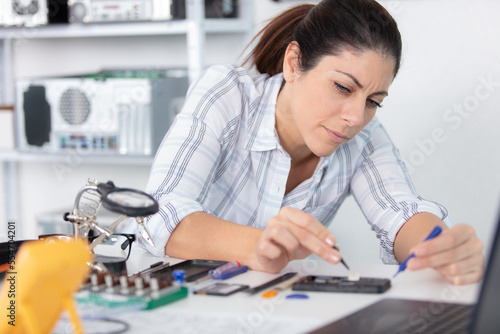 woman mesuring the voltage of a pc photo