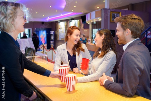 Obraz na plátně young people being served popcorn and drinks at cinema