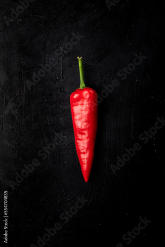 Fresh red pepper. Red big chilies called Pepperoni on a dark background.
