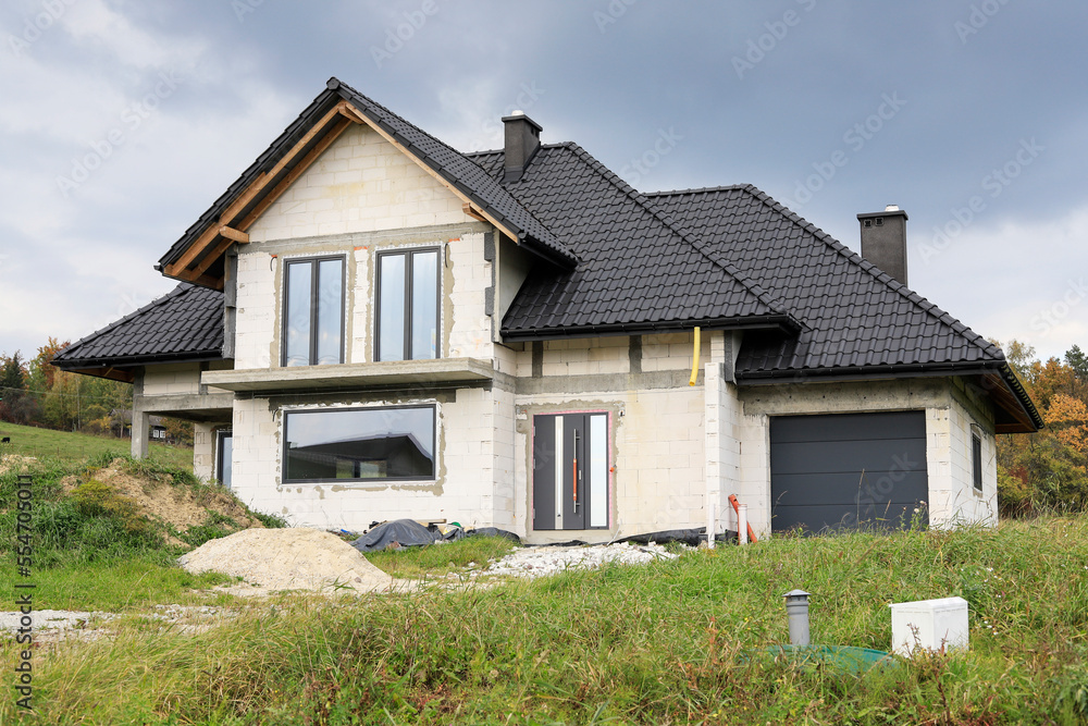 KRAKOW,POLAND - SEPTEMBER 23, 2021: Construction site of a detached house in Krakow, Poland. KRAKOW,POLAND - SEPTEMBER 23, 2021: Construction site of a detached house in Krakow, Poland.