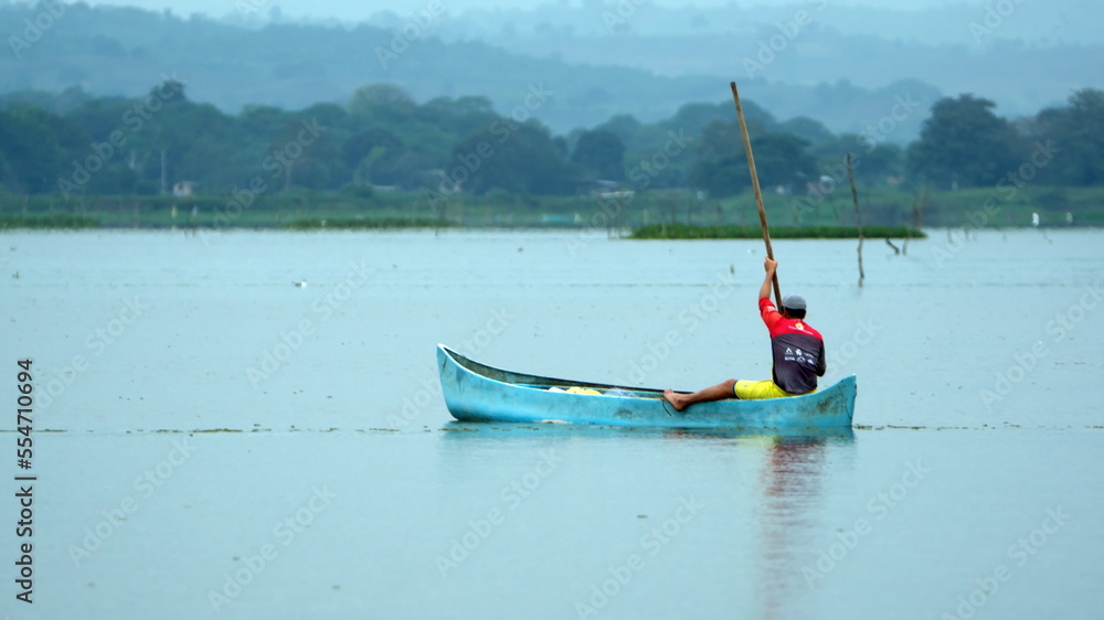 Man poling a boat at the La Segua wetlands near Chone, Ecuador