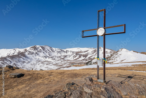 Scenic view on the snow capped mountain summits Zirbitzkogel and Kreiskogel seen from the summit cross of mountain peak Hohe Ranach, Seetal Alps, Styria, Austria, Europe. Hiking trails in early spring