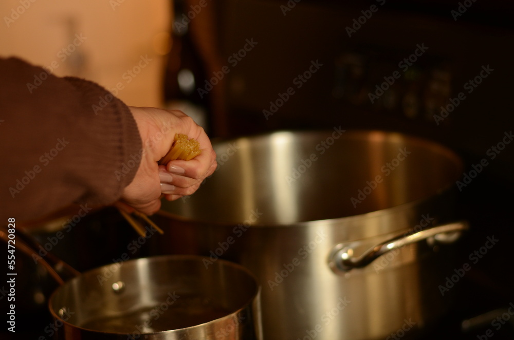 young woman cooking pasta in home kitchen young woman cooking pasta in home kitchen