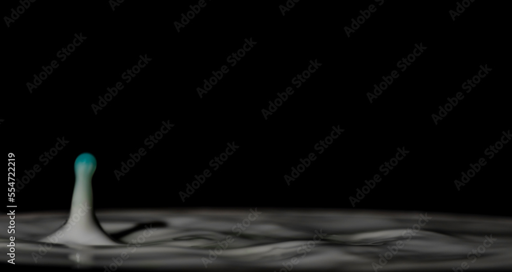 Drop of milk with big waves on surface with black background Drop of milk with big waves on surface with black background